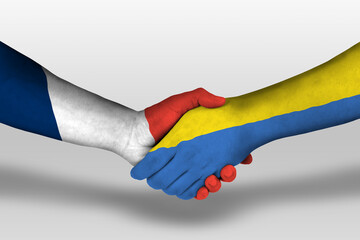 Handshake between ukraine and france flags painted on hands, illustration with clipping path.