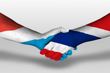 Handshake between thailand and luxembourg flags painted on hands, illustration with clipping path.