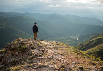 The traveler on the top of the mountain looks into the distance