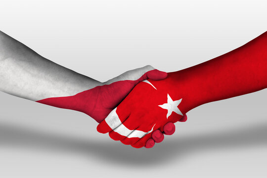 Handshake between turkey and poland flags painted on hands, illustration with clipping path.