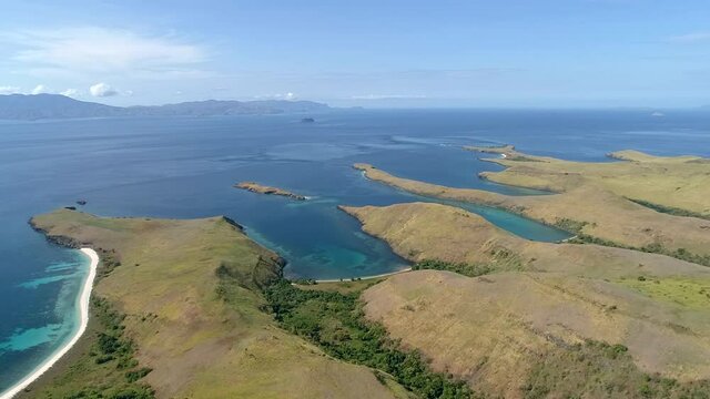 Wild islands of Indonesia. Flores. tropical paradise. Labuan Baggio. drone shooting. Wild beaches, blue logons, coral reefs, green hills. aerial view. boat trip safari. 
