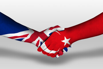 Handshake between turkey and united kingdom flags painted on hands, illustration with clipping path.