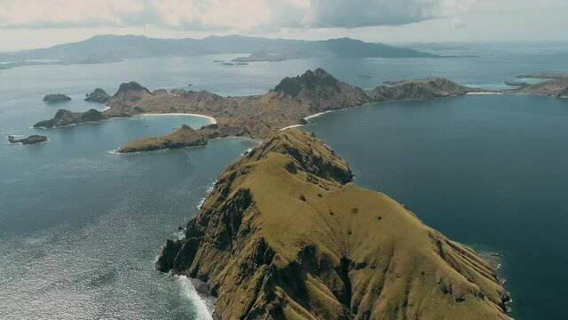 Padar island.pink beach.Wild islands of Indonesia. Flores. tropical paradise. Labuan Baggio. drone shooting. Wild beaches, blue logons, coral reefs, green hills. aerial view. boat trip safari. 