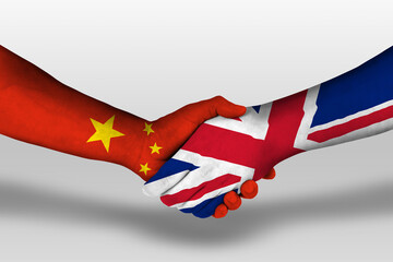 Handshake between united kingdom and china flags painted on hands, illustration with clipping path.