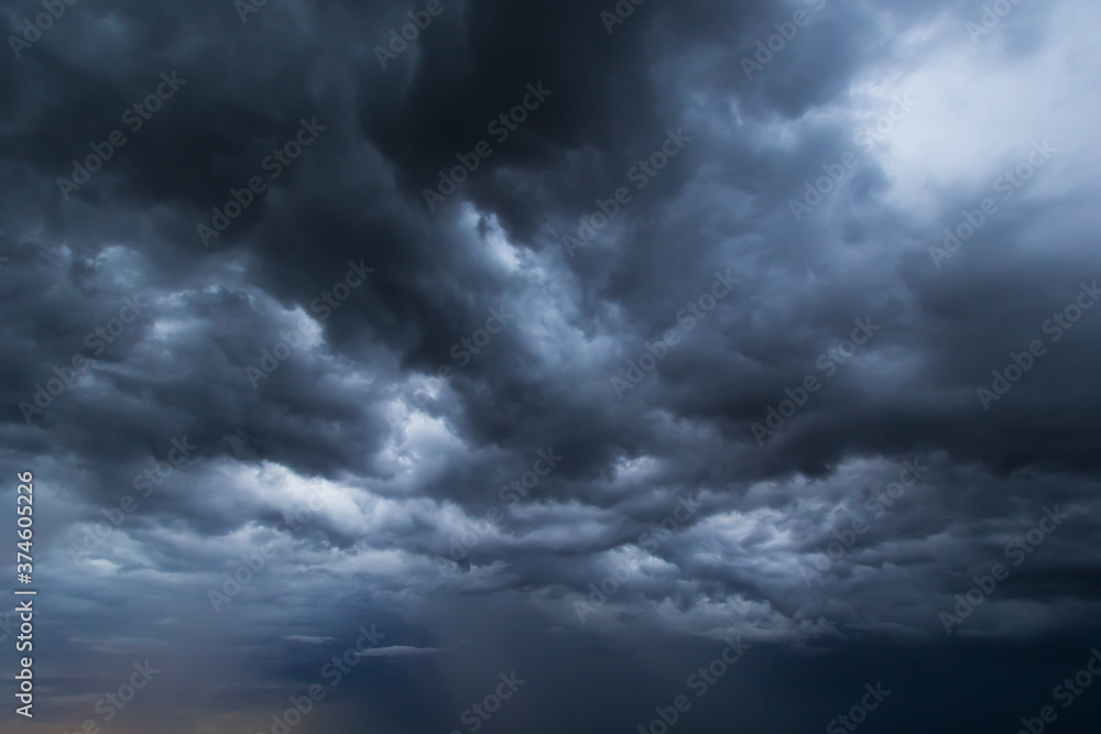 Poster the dark sky had clouds gathered to the left and a strong storm before it rained.bad weather sky.
