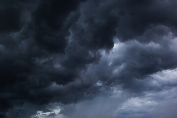 The dark sky with heavy clouds converging and a violent storm before the rain.Bad or moody weather...