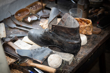 19th century shoemaker, leather worker tools.Vintage, authentic tools. Old leather shoe under...