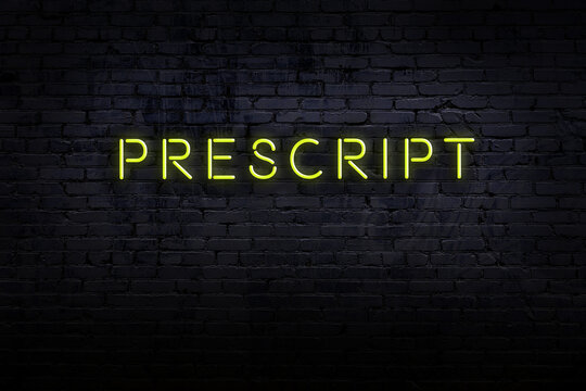 Night view of neon sign on brick wall with inscription prescript