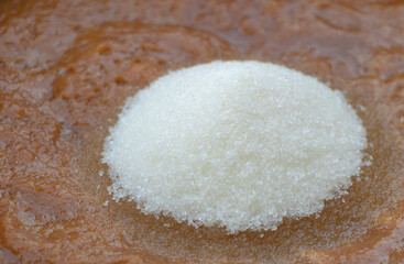 Fototapeta na wymiar In the process of cooking jam - we put the amount of sugar. Sugar in the jam