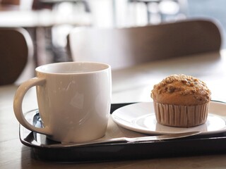 Blueberry muffins cupcake serve with hot big coffee cup  on tea break 