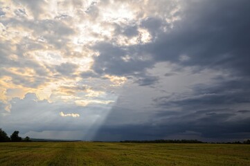 A ray of sun shines from behind the clouds