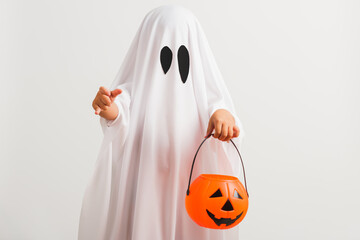 Funny Halloween Kid Concept, little cute child with white dressed costume halloween ghost scary he...