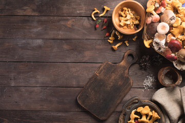 Autumn harvest of mushrooms on vintage rustic wooden background. Rustic kitchen table. Flat lay top, top view . Layout with free text space. Forest harvest concept.