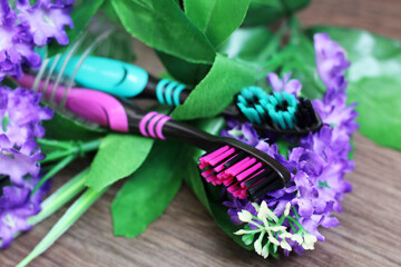 Two toothbrushes with beautiful flowers. Healthcare object.