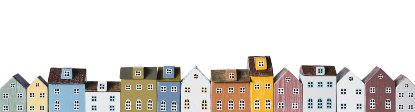 Row of miniature colorful retro houses on white background