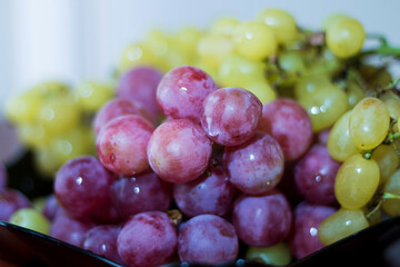 Red and White wine bunch of grapes in the black plate