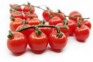 Cherry tomatoes isolated on a white background. Red tomatoes on a twig