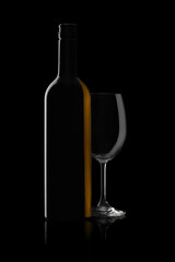 Bottle and glass of red wine on black background