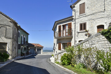 Fototapeta na wymiar A narrow street among the old houses of Cercemaggiore, a rural village in the Molise region.