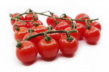 Cherry tomatoes isolated on a white background. Red tomatoes on a twig