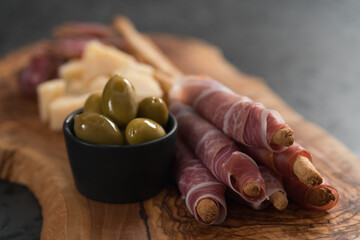 Italian snacks on olive wood board