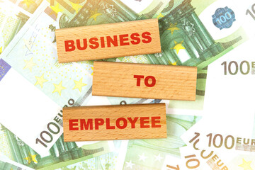 Against the background of euro bills, the text is written on wooden blocks - business to employee