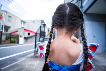 Asian little girl walking on street
