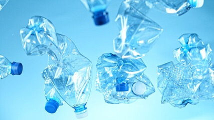 Freeze Motion Shot of Flying Plastic Waste on Blue Gradient Background