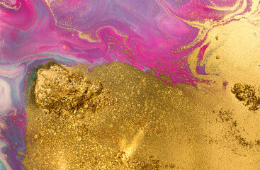 Piles of gold sequins on pink smudges of paint. Abstract pattern.