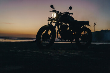 Obraz na płótnie Canvas Custom motorbike in the beach at sunset in Bali Indonesia