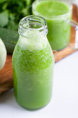 Organic cold-pressed raw vegetable juice. Cucumber drink with herbs.