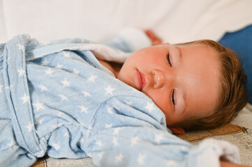 Close up of boy (1-2) sleeping in bed, little dreamer. 