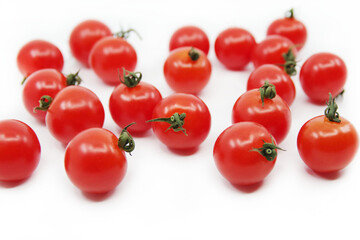 Cherry tomatoes isolated on a white background. Red tomatoes on a twig
