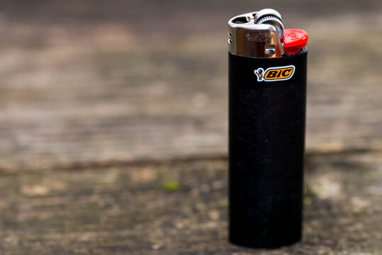 Miercurea Ciuc, Romania- 30 August 2020: Black Bic cigarette lighter on aged pine wood boards, space for text.