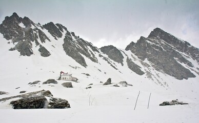 White house on top of the Carpathian mountains covered with snow in Romania.