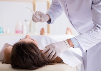 Police coroner examining dead body corpse in morgue