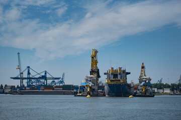 Fototapeta premium container ships with cranes in the harbor of rotterdam netherlands
