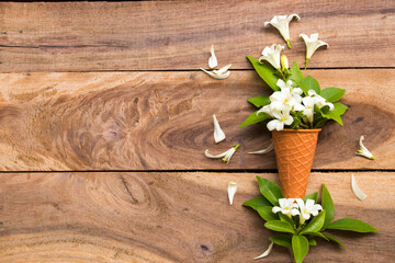 white flowers jasmine local flora of asia in cone arrangement flat lay postcard style on background wooden