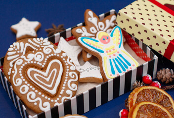 Christmas gingerbread handmade decorated with patterns and covered with icing. Cozy atmosphere. New year's eve concept.