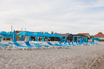 white sun loungers on the sandy beach