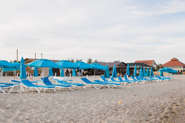 white sun loungers on the sandy beach