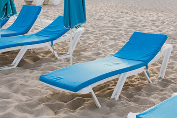 white sun loungers on the sandy beach