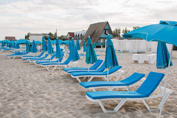 white sun loungers on the sandy beach