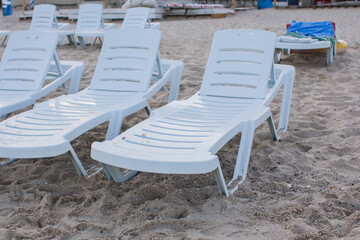 white sun loungers on the sandy beach