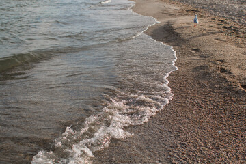 sandy seashore with clear sea water
