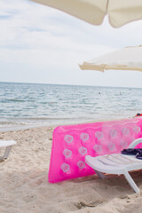 pink inflatable mattress on the seashore