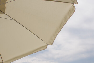 beach umbrella against the sky with clouds