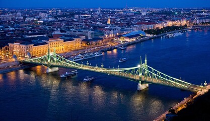 Beautiful view of Liberty Bridge at night. It was built in 1896 and rebuilt in 1945 and connects...
