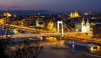 Fototapeta premium View from Gellert hill of night Danube river, Elizabeth Bridgewith lights and Pest part of the city with Sziget's Eye (ferris wheel) and St. Stephen's Basilica. Budapest, Hungary..