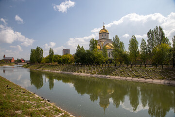 Fototapeta na wymiar View of Akbulak river and Ukrainian Greek-Catholic Church in Nur-Sultan, the capital of Kazakhstan.